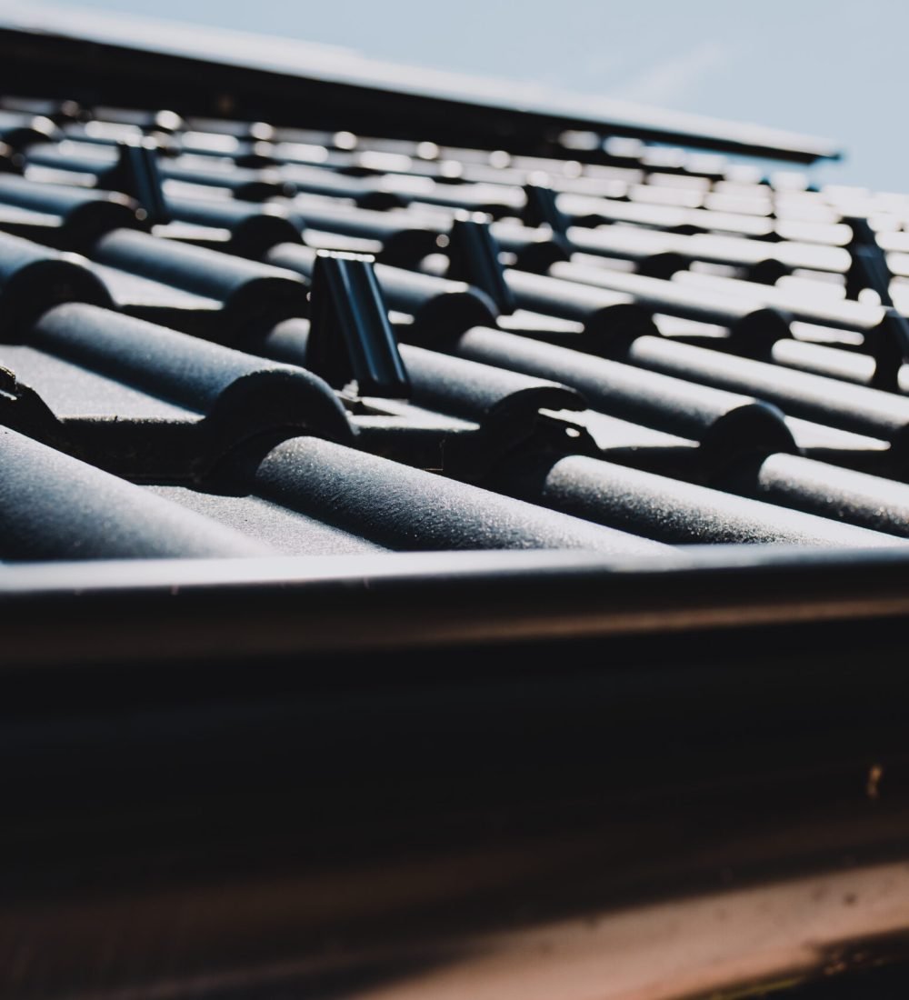 Close-up of snow guards securing metal roof tiles, ensuring safety and preventing snow slides on a residential building